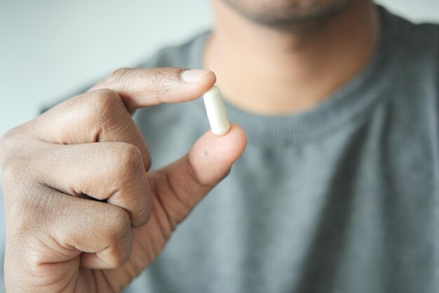 Close up of man hand holding pills with copy space