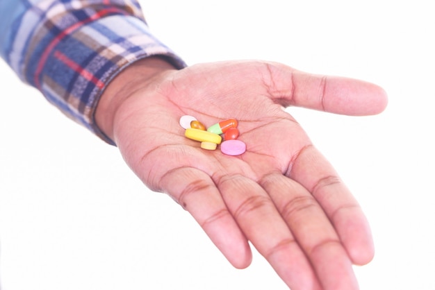 Photo close up of man hand holding pills with copy space