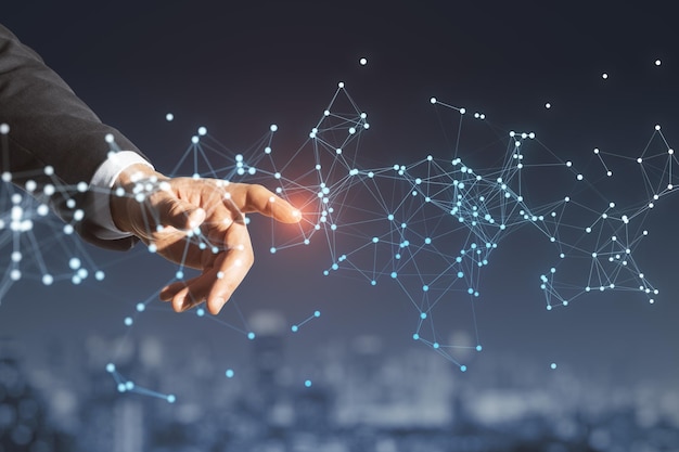 Close up of man hand pointing at glowing polygonal mesh on blurry night city background Technology network and connections concept Double exposure