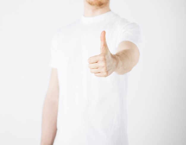 close up of man hand showing thumbs up