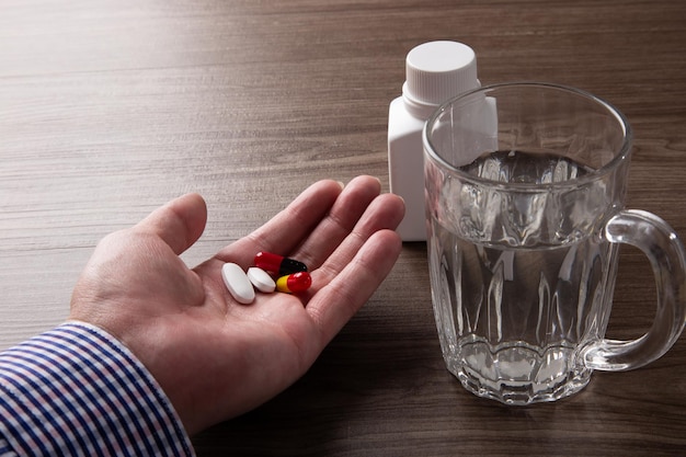 Close up of man hand taking pills