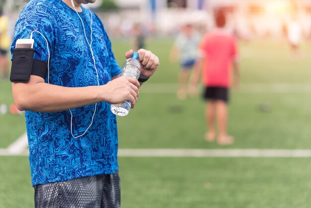 Close up of man hand using bottle of water