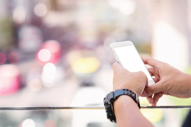 Close up of man hand using mobile phone in the street