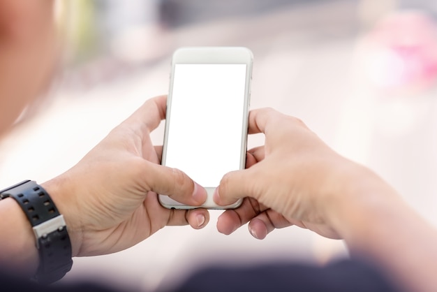 Close up of man hand using mobile phone in the street