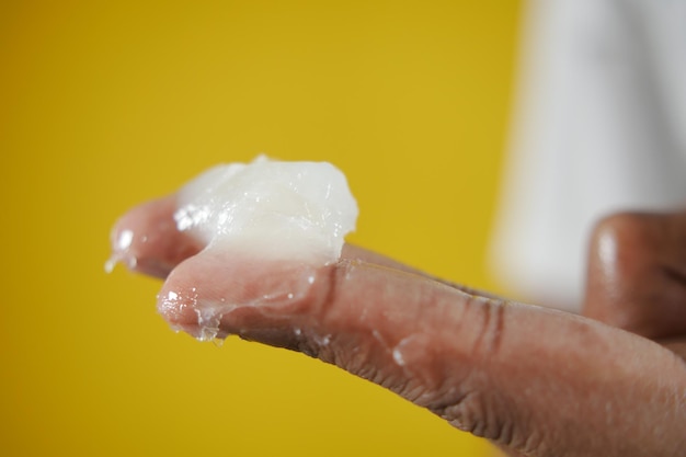 Close up of man hand using petroleum jelly