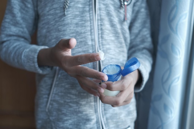 close up of man hand using petroleum jelly