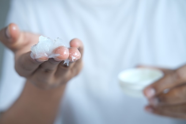 close up of man hand using petroleum jelly