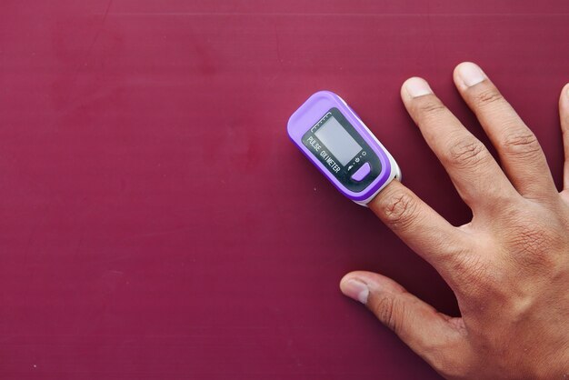 Close up of man hand using pulse oximeter