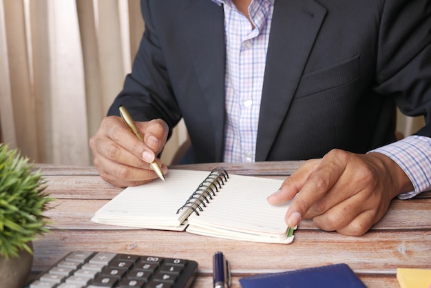 Close up of man hand writing on notepad