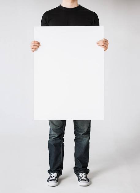 close up of man hands showing white blank board