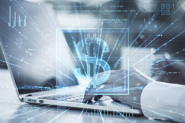 Close up of man hands using laptop on desk with coffee cup glowing dollar sign hologram on blurry outdoor background Online banking trade finance and blockchain concept Double exposure