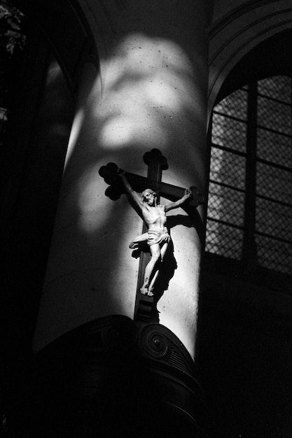 Close-up of man hanging against statue