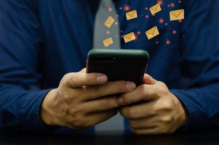 Close-up man holding a cell phone an icon email message. Marketing business sending information to customers or hacking online transactions. Business concept technology.