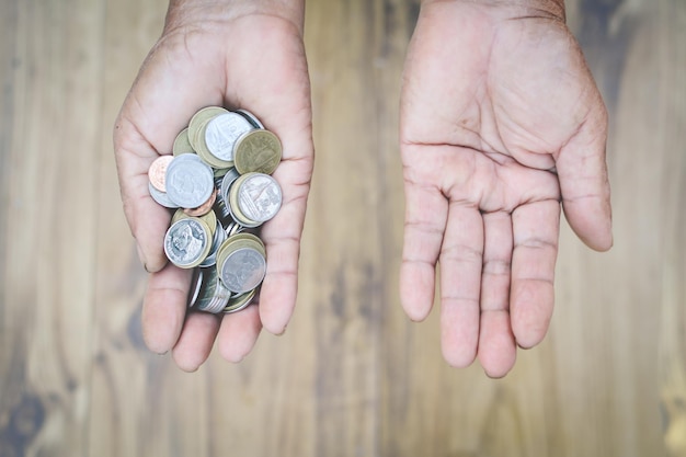 close up of man holding coins