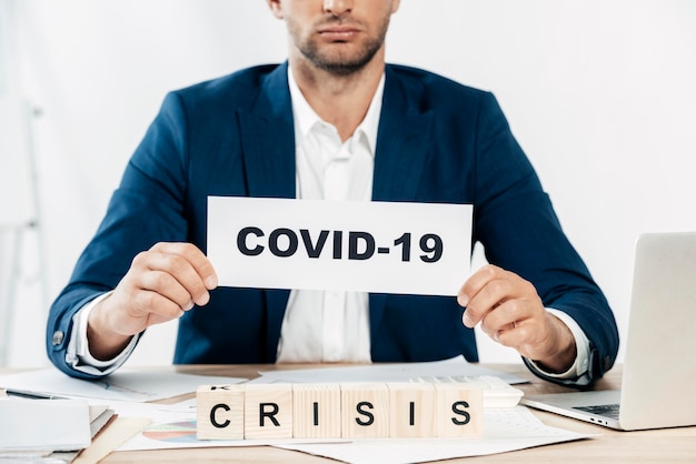 close-up man holding covid19 sign