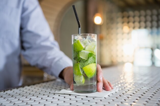 Close-up of man holding glass of gin