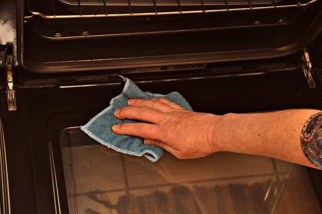 Photo close-up of man holding hands at home