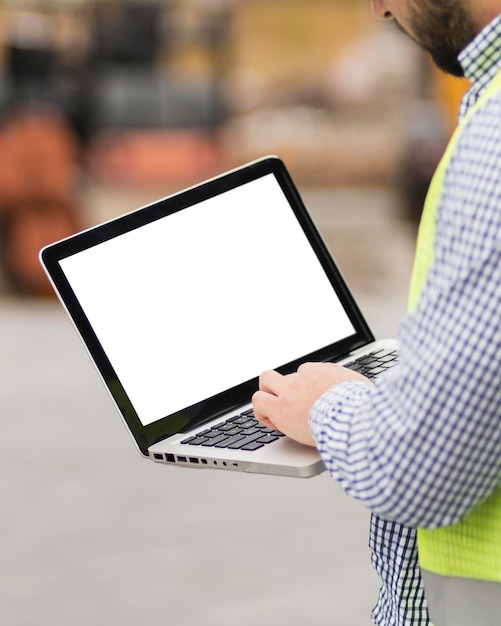 Close-up man holding laptop