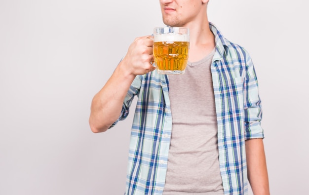 Close up of man holding a mug of beer. Background with copy space.