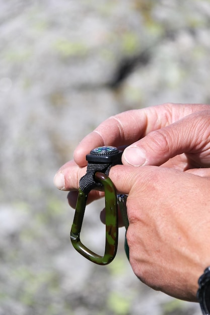 Photo close-up of man holding navigational compass