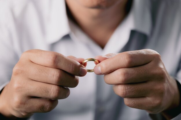 Close-up of man holding ring at home, Thinking about wedding