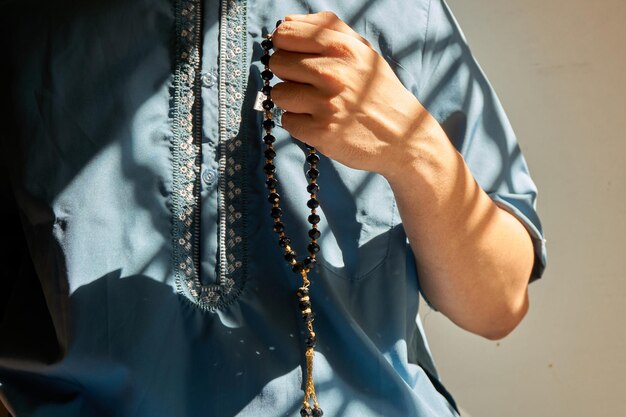 Close-up of man holding rosary