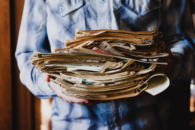 Close-up of a man holding stack