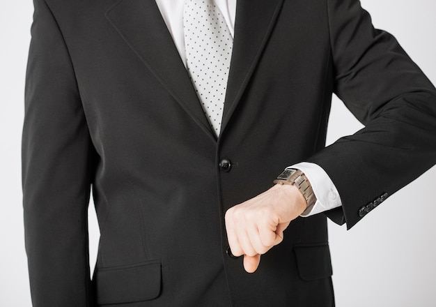 close up of man looking at wristwatch