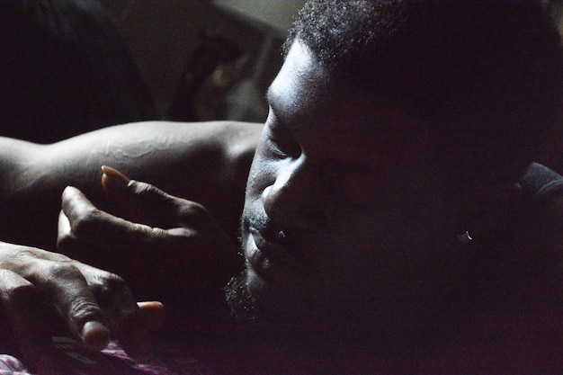 Close-up of man lying at home