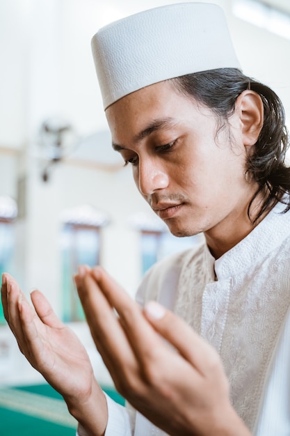 Close up man muslim doing prayer in the mosque