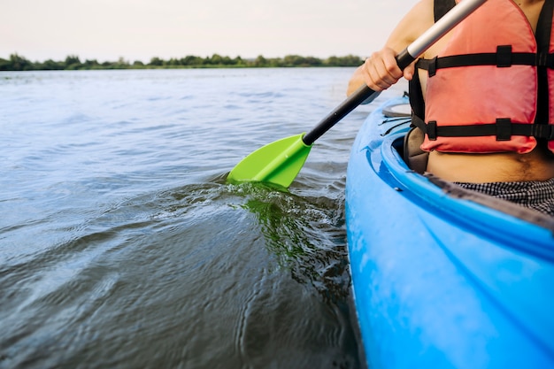 Close-up of man paddling kayak