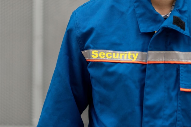 Close up man person in uniform with words security guard on it