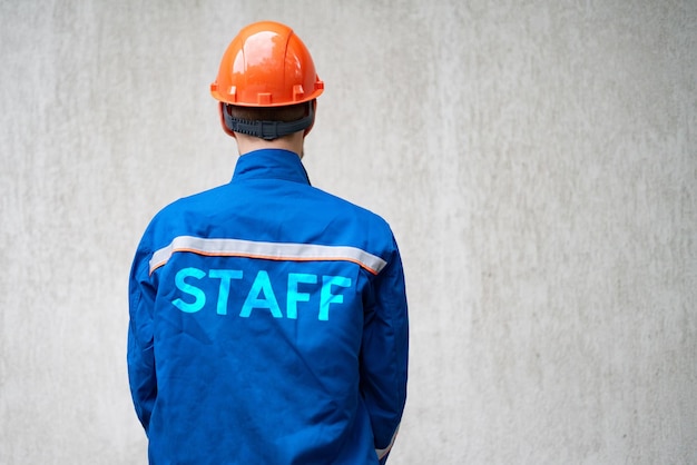 Close up man person in uniform with words staff on it