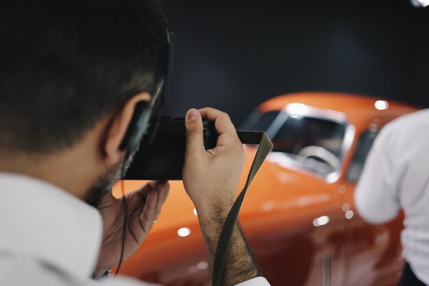 Close-up of man photographing car