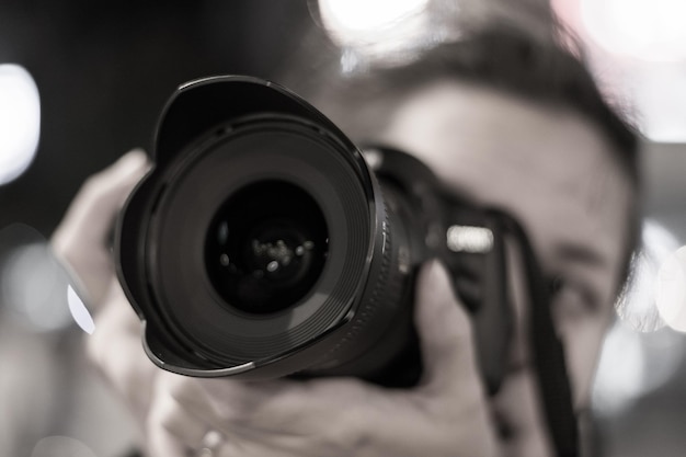 Close-up of man photographing with camera