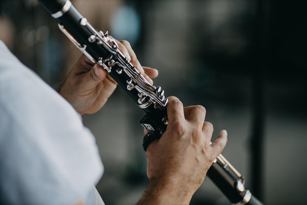 close up man playing clarinet
