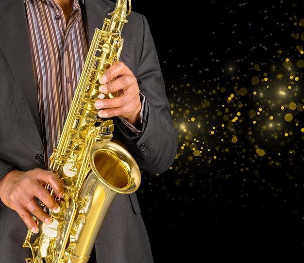 Close-up man playing on saxophone on  background