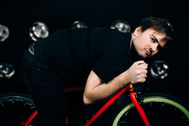 Close up on man posing with a bicycle
