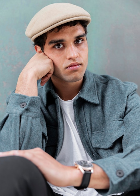 Close up man posing with hat