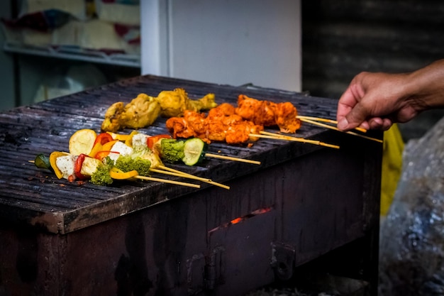 close-up of man preparing food on barbecue grill