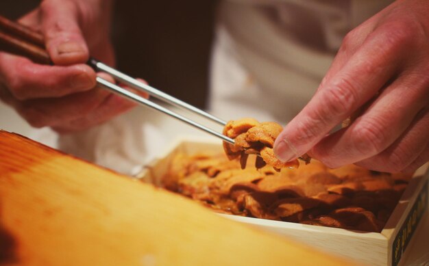 Close-up of man preparing food