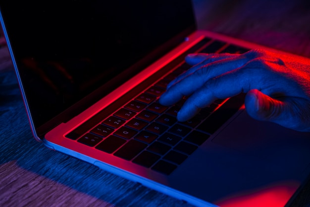 Close up of man's hand on laptop