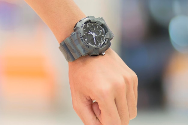 Close-up of a man's hand wearing a gray watch