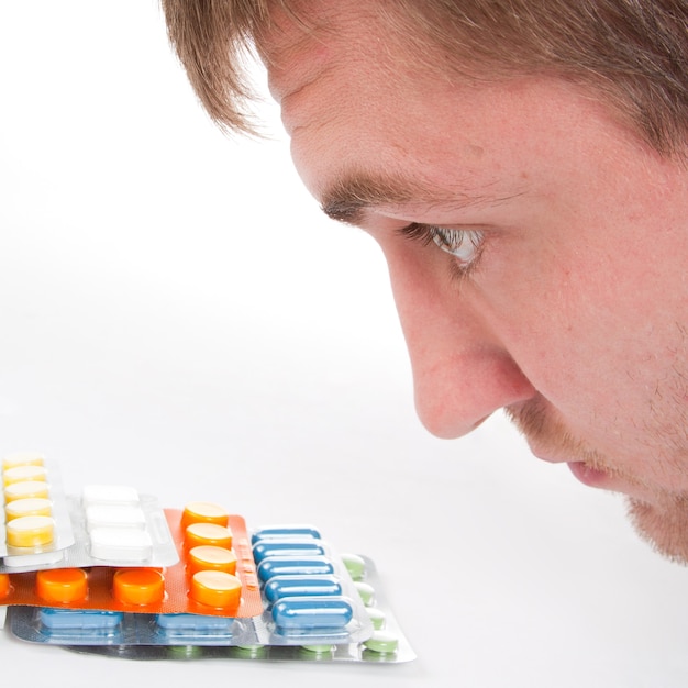 Photo close-up of man's head and colorful medicines