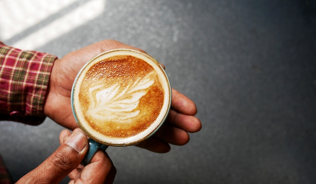 Close up of man serving coffee in coffee shop.