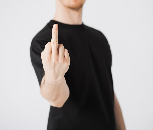 close up of man showing middle finger