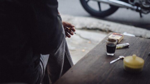 Close-up of man smoking on table