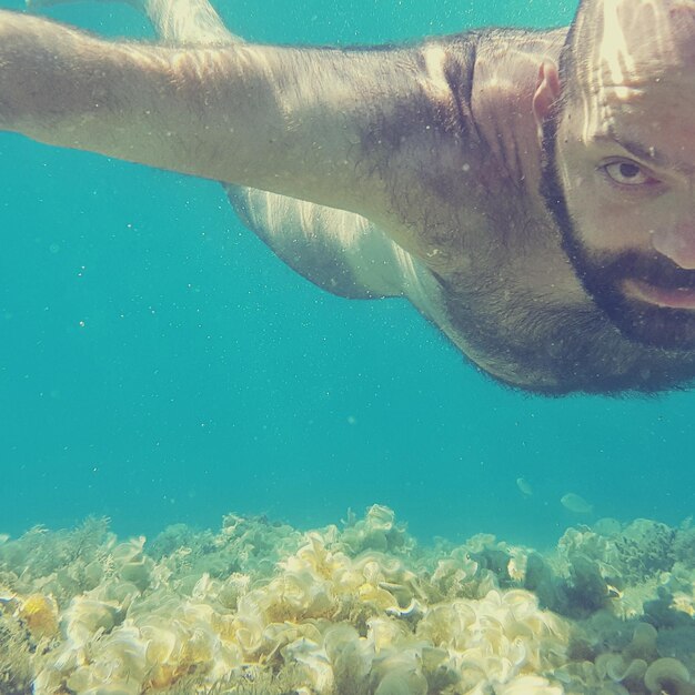 Close-up of man swimming in sea