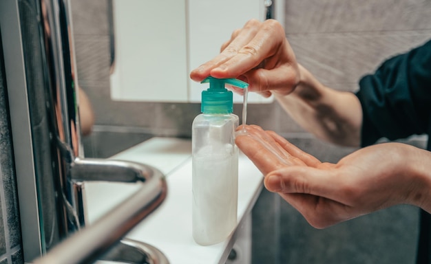 Close up man using bactericidal soap for washing hands