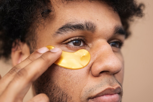 Close up man using eye patch